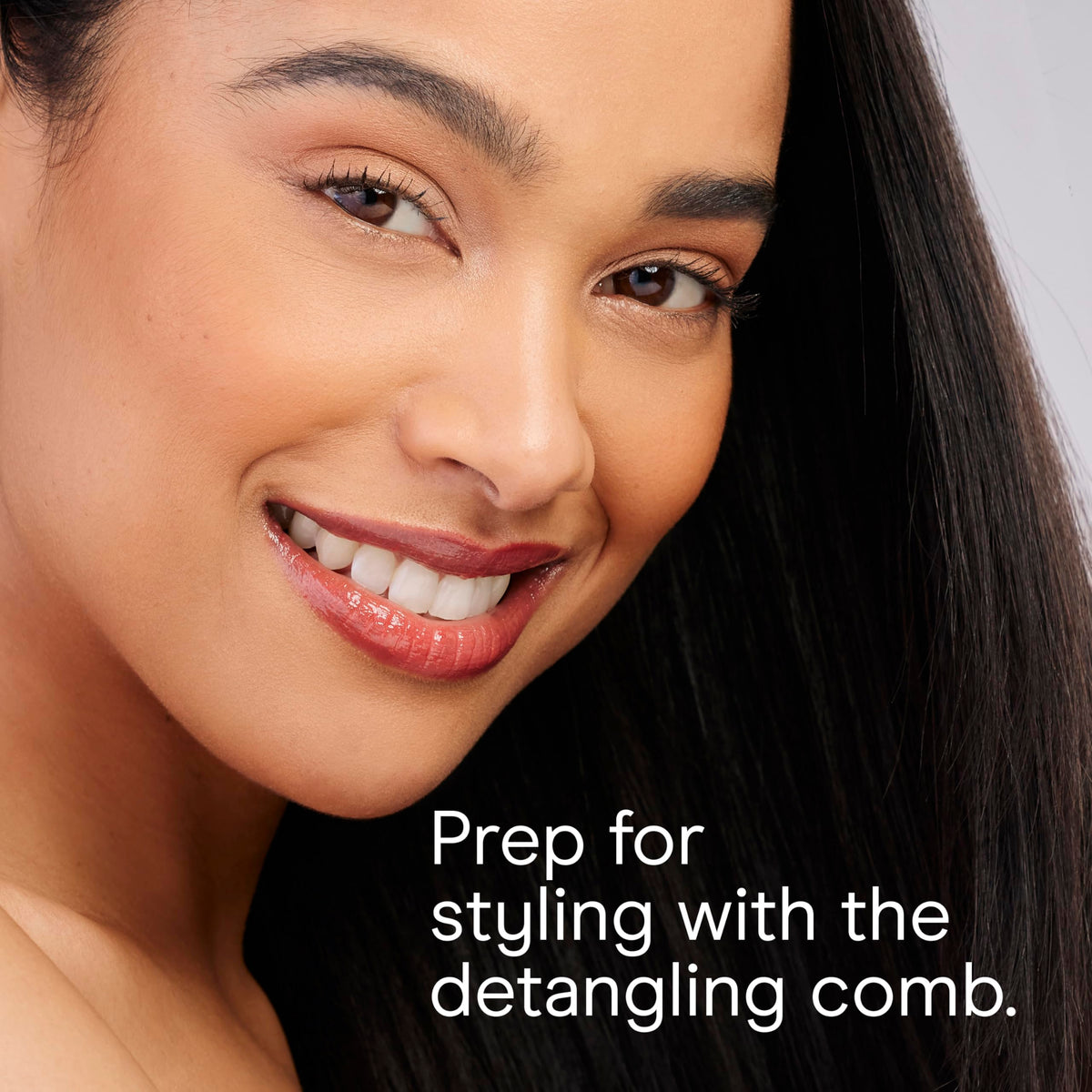 Conair dryer held in hand to show compact size and travel-ready portability