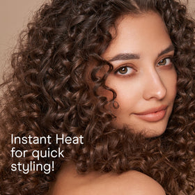 Conair held in hand to show 1/2 inch barrel size for tight ringlet curls