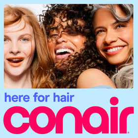 Conair travel hair dryer next to a phone to show compact size