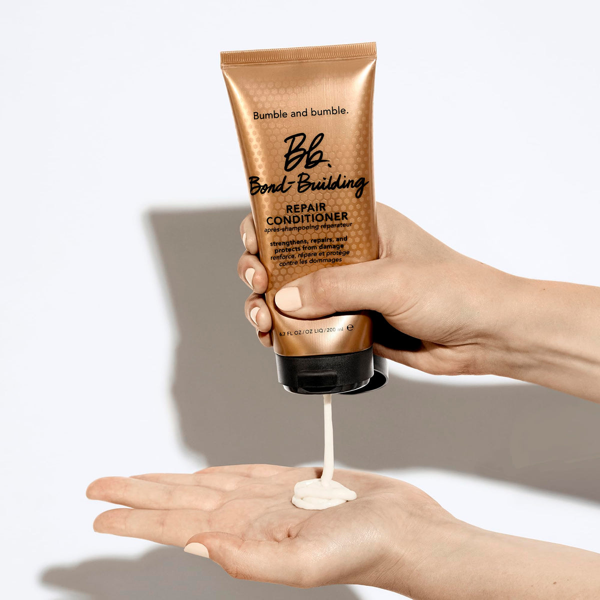 bumble and bumble conditioner applied to wet hair in shower improving manageability