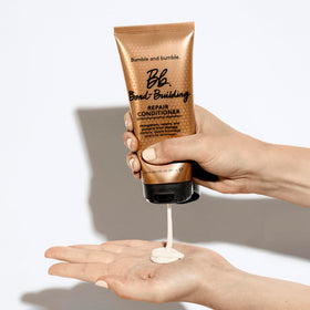 bumble and bumble conditioner applied to wet hair in shower improving manageability