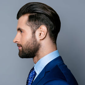 Consort bottle next to hand showing 8.3 oz size and portability