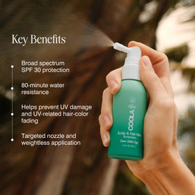COOLA hand applying scalp spray for targeted sun protection