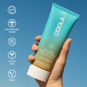 COOLA application on forearm showing smooth coverage and hydrated finish