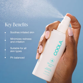 COOLA bottle in hand showing 3.4 oz size and portable benefit