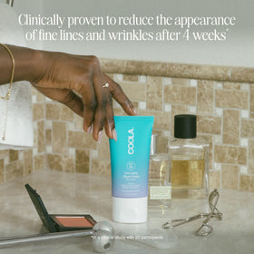 COOLA hand cream being applied showing smooth, non-greasy finish