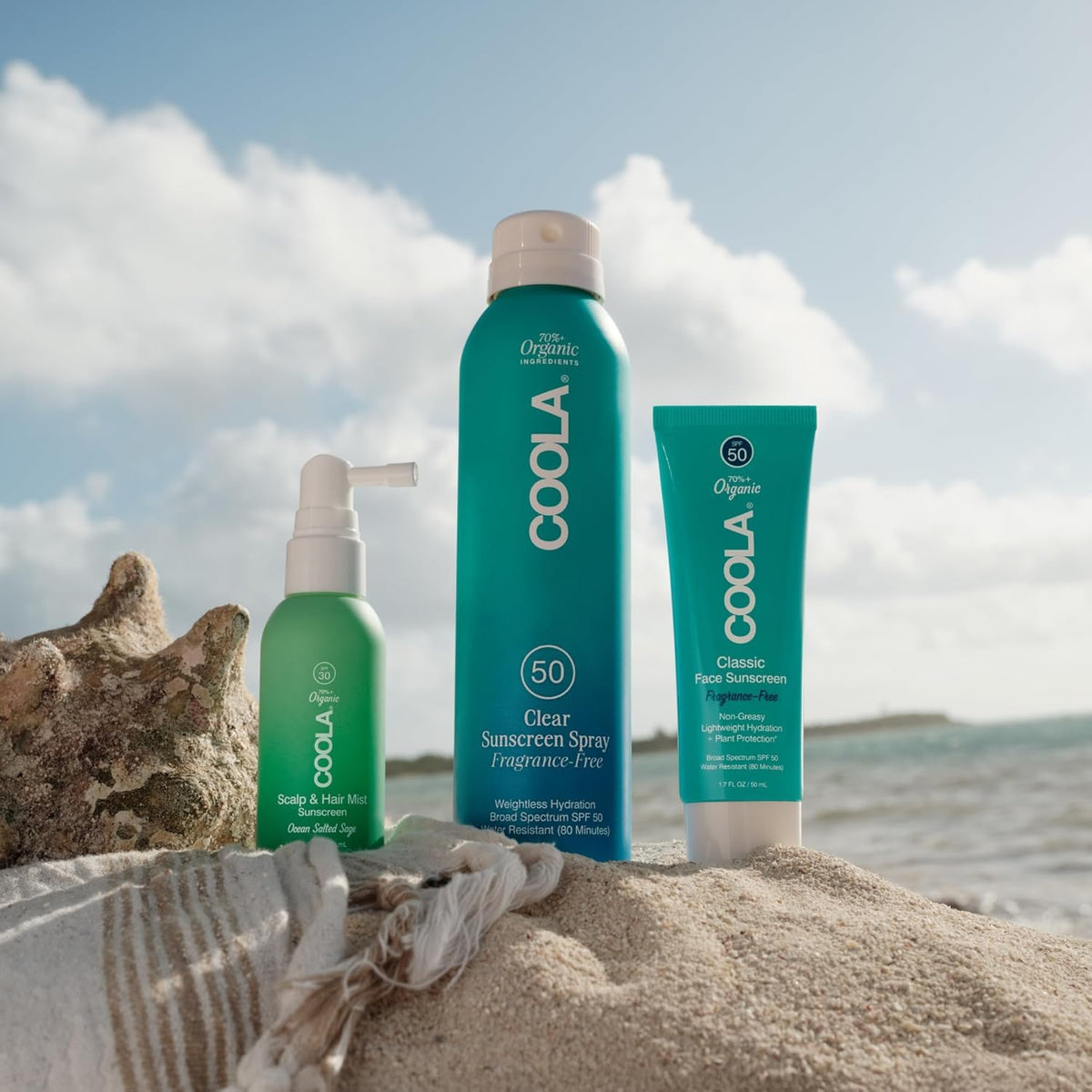 COOLA in beach setting conveying ocean salted sage scent and outdoor sun defense