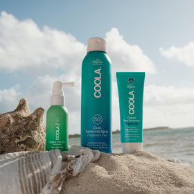 COOLA mist used on beach illustrating outdoor scalp protection
