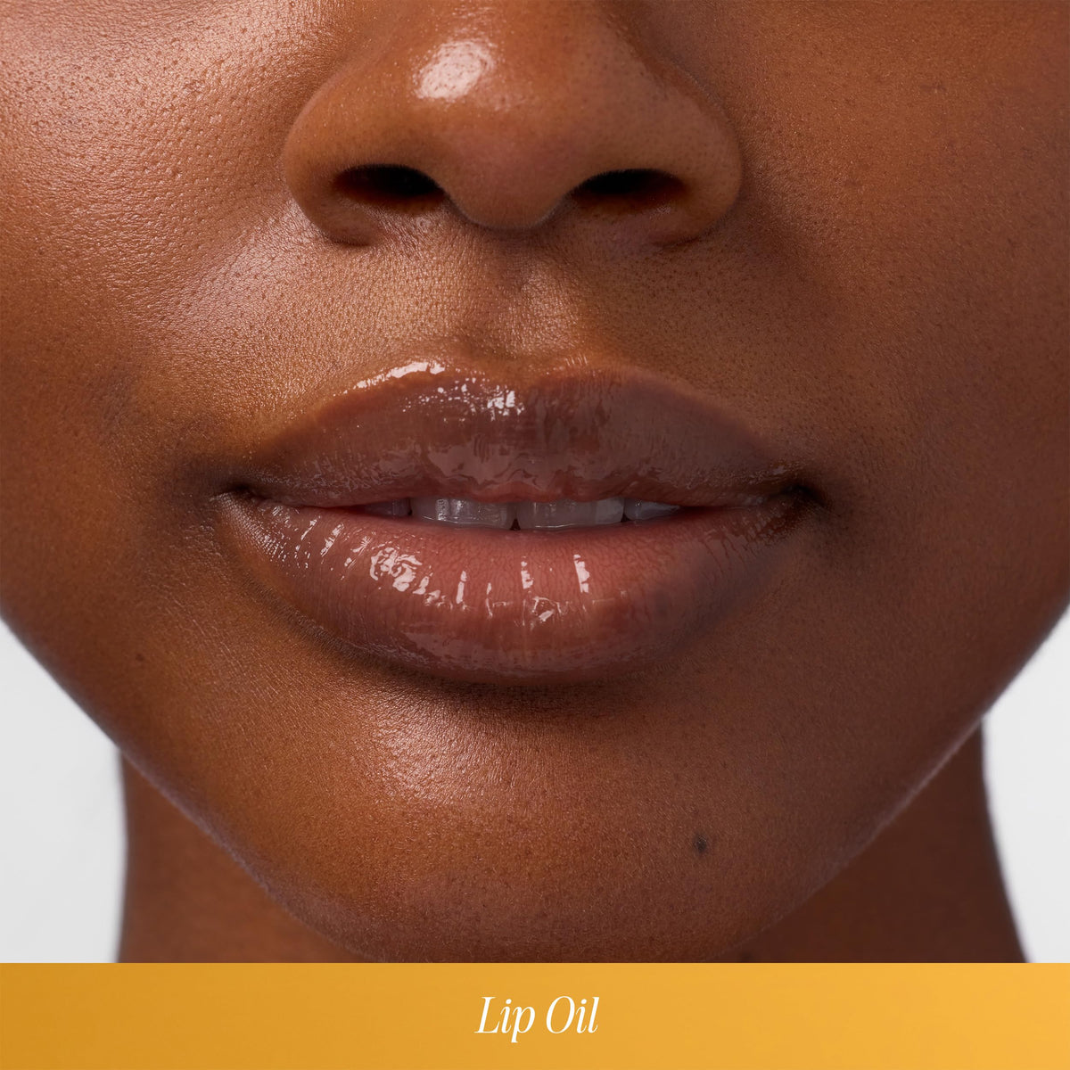 COOLA lip oil applied on lips demonstrating glossy hydration and subtle shine