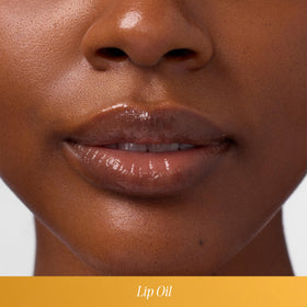 COOLA lip oil applied on lips demonstrating glossy hydration and subtle shine