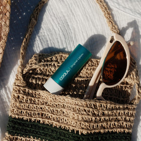 COOLA Liplux raspberry and avocado butter close-up highlighting hydration