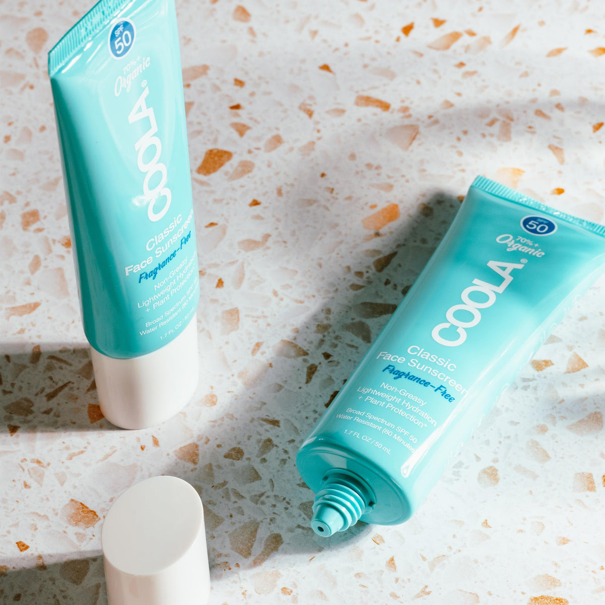 COOLA in outdoor beach setting illustrating broad-spectrum protection benefit