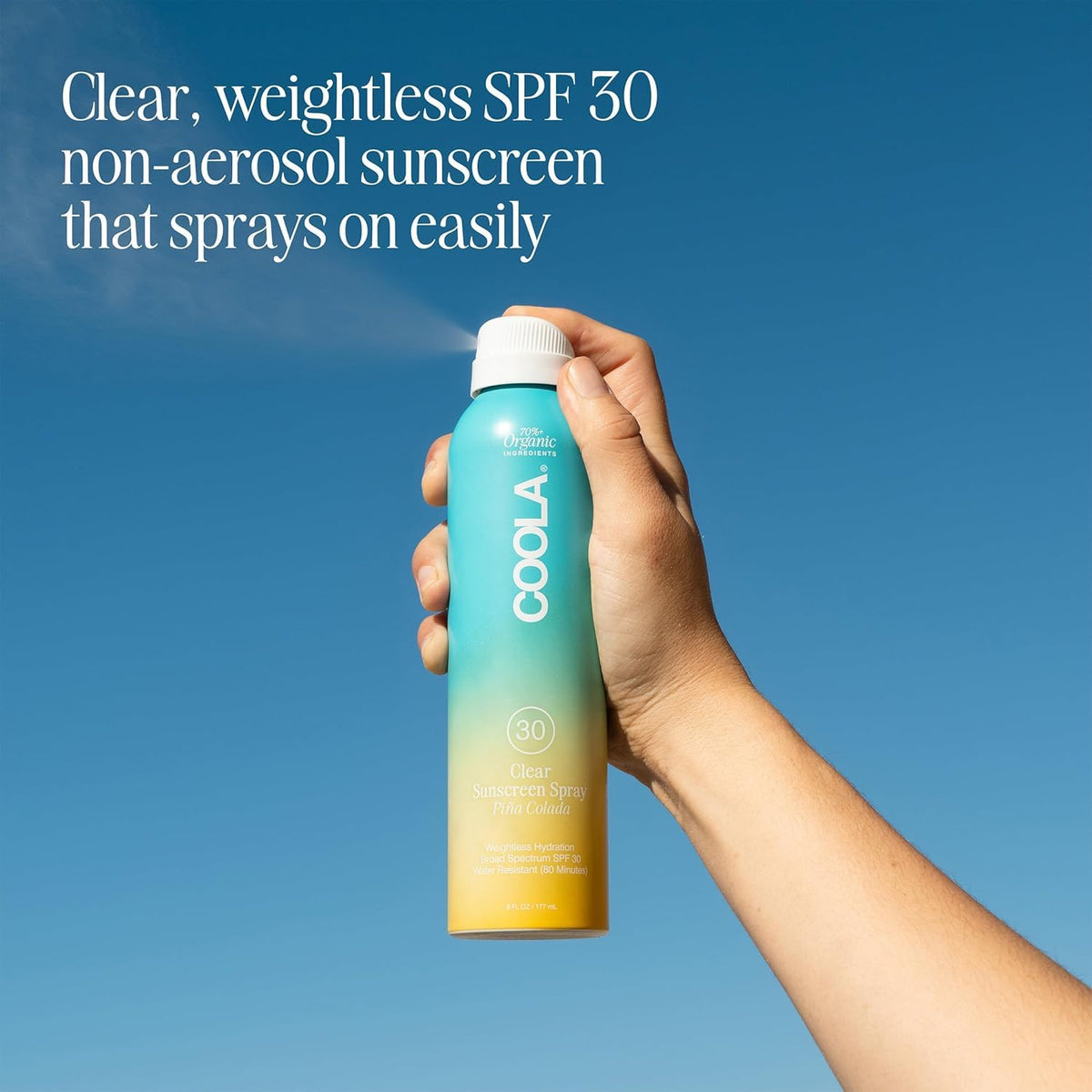 COOLA spray nozzle detail demonstrating continuous mist for quick full-body coverage