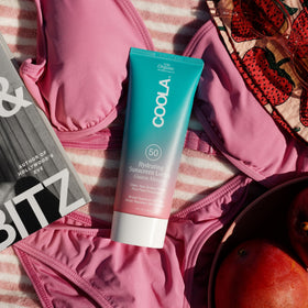 COOLA pump dispensing lotion showing controlled amount and mess-free use