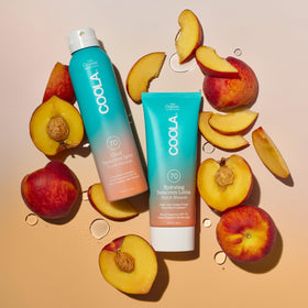 COOLA bottle held in hand illustrating 6 fl oz size for portability
