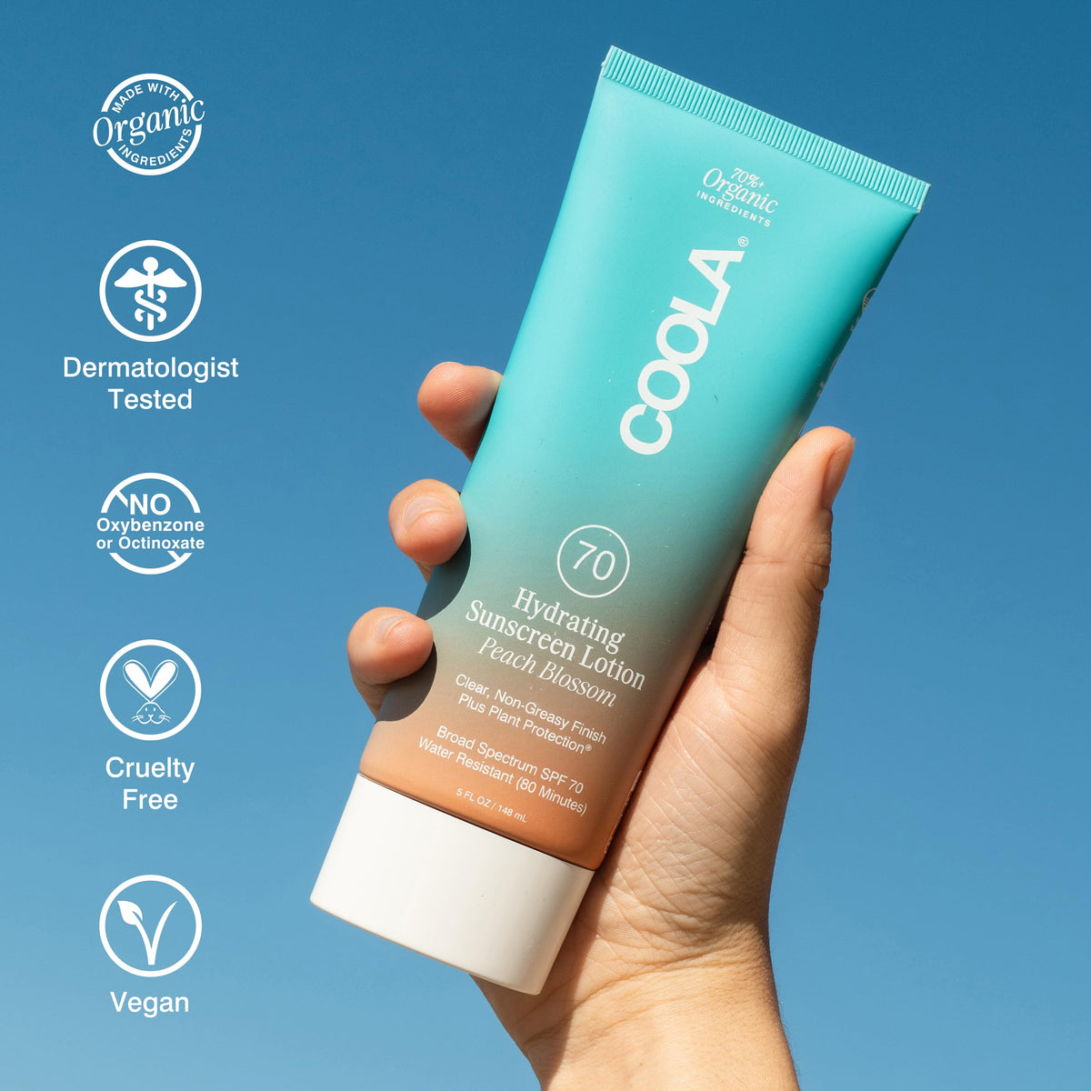 COOLA lotion spread on forearm showing sheer finish and non-greasy hydration benefit