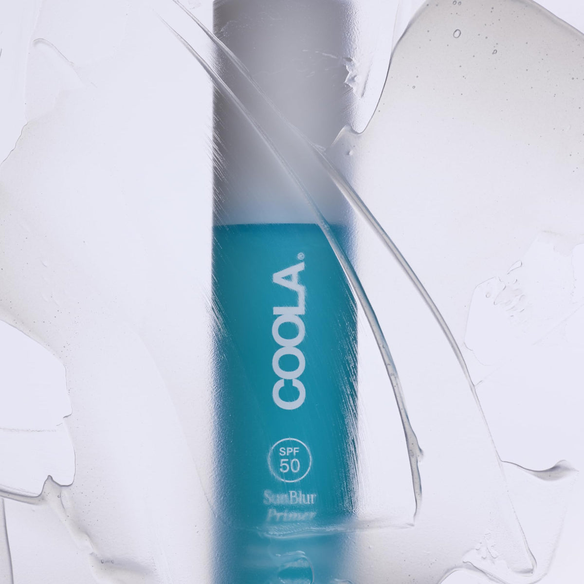 COOLA primer swatched on hand showing lightweight spreadability