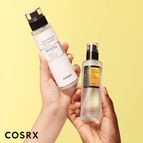 COSRX bottles in hand for scale showing travel-friendly sizes
