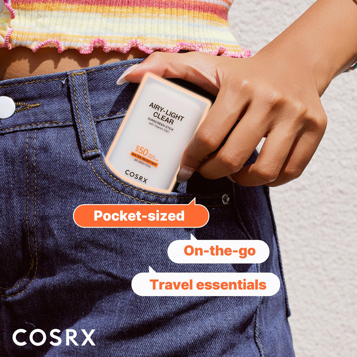 COSRX sunscreen stick next to keys to show pocket-sized convenience
