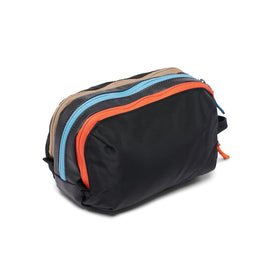Cotopaxi Nido accessory bag open to reveal three compartments and interior zip pocket for organized packing benefit