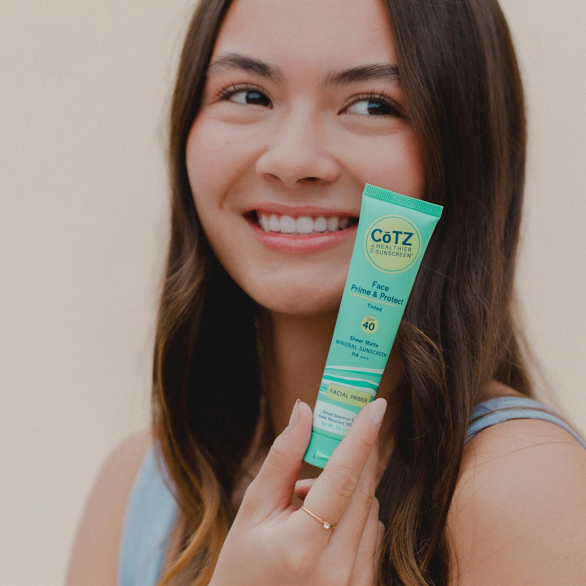 CoTZ application on face with fingers illustrating easy blending and primer effect