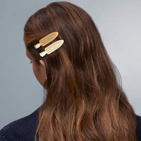 Cptots clips arranged on vanity showing versatile, salon-ready styling