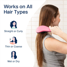Crave Naturals brush held in hand to show 7.5x3 inch size for portability