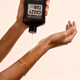 Crazytan 8oz bottle in hand demonstrating compact size and travel convenience