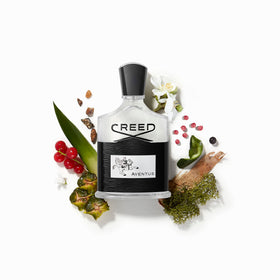Creed Aventus poured beside a glass highlighting color benefit: refined texture and clarity