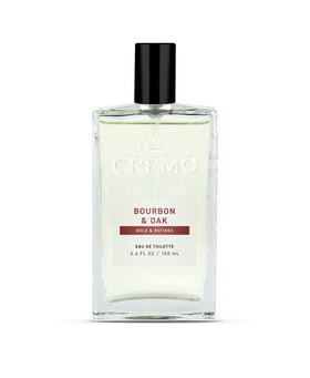 Cremo bottle front view showing refined bourbon and oak fragrance benefit