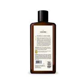 Cremo bottle held by hand to show 16 oz size and travel-friendly benefit