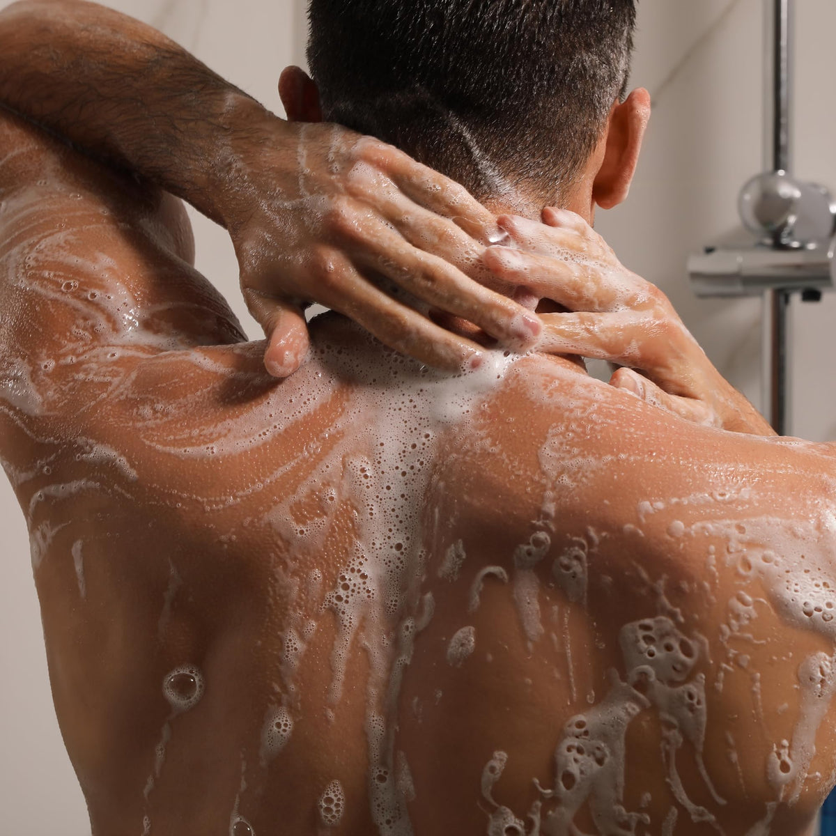 Cremo creamy lather on hand illustrating hydration and rich foam
