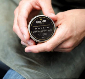 Cremo balm warming on fingertips for smooth application and even distribution