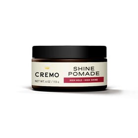 Cremo in‑hand application with product on fingertips demonstrating controlled styling benefit