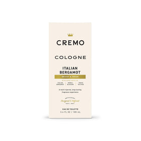 Hand holding Cremo bottle showing scale and carry-on suitability