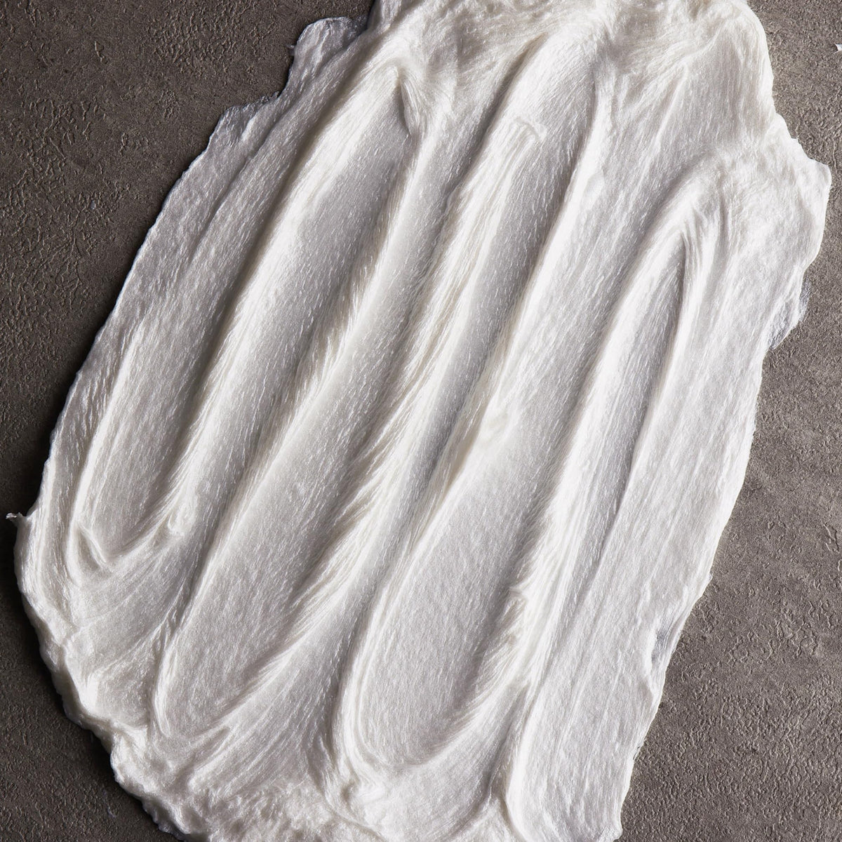 Cremo lather on skin demonstrating thin, protective layer that reduces razor drag