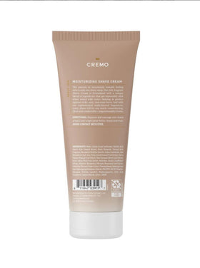 Cremo bottle held in hand to show scale and travel-friendly 6 fl oz size