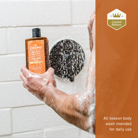 Cremo bottle placed in a wet shower setting highlighting water-friendly use benefit