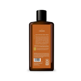Cremo bottle on bathroom shelf among grooming items showing premium routine fit benefit