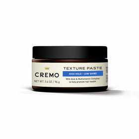 Cremo jar beside ruler showing 3.4 oz size for travel convenience