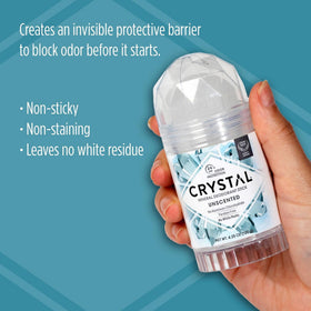 Crystal Essence applying stick to underarm, gentle odor control during daily routine