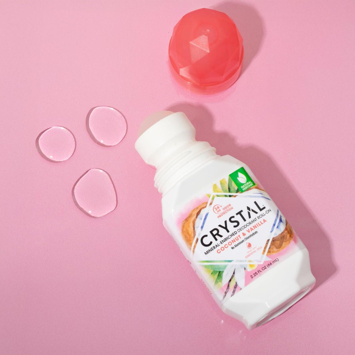 Crystal Essence held in hand to show 2.25oz scale and travel ease