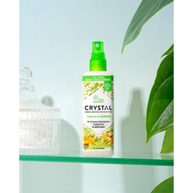 Crystal Essence fine mist on skin showing quick-dry non-sticky finish benefit