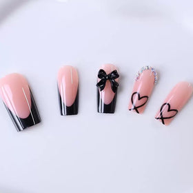 CTTHNBD hand model wearing medium coffin press-ons to show scale and wearable length