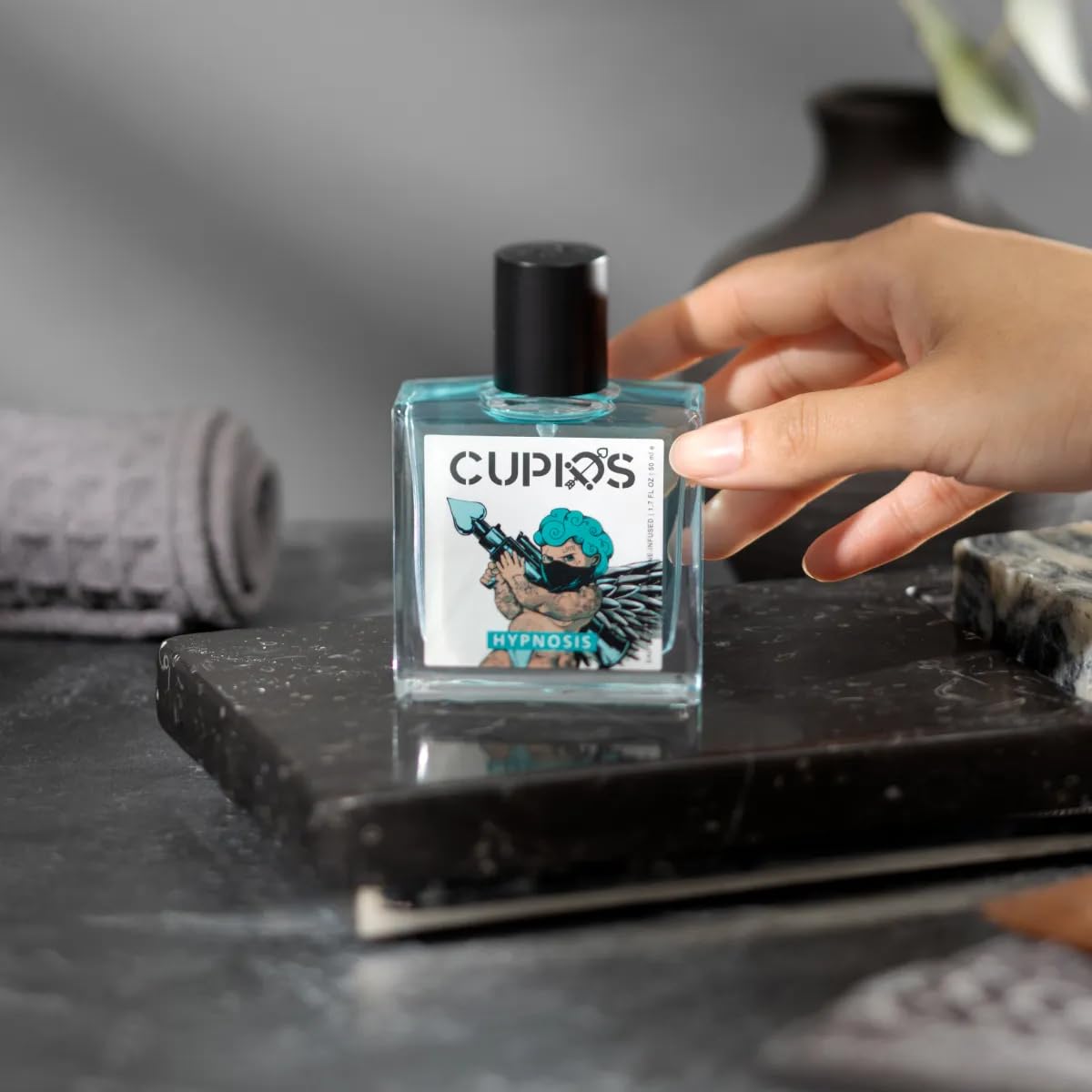 Cupids Hypnosis 2.0 50ml beside passport showing travel-friendly size and convenience