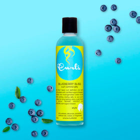Curls blueberry bliss being applied to wet hair for definition and frizz control