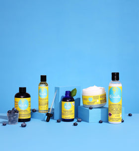 Curls Blueberry Bliss applied to hair in hand demonstrating easy detangling and reduced breakage