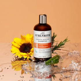 CURLSMITH bottle held in hand showing scale and travel-friendly size