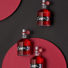 Curve bottle in evening social setting conveying confident, approachable scent