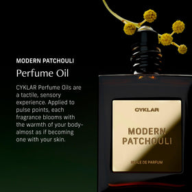 CYKLAR roll-on in hand applying perfume oil for precise control and no waste